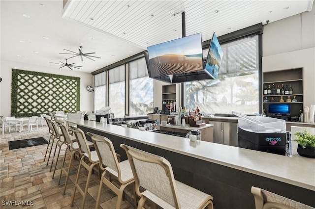 kitchen featuring stone finish floor and ceiling fan