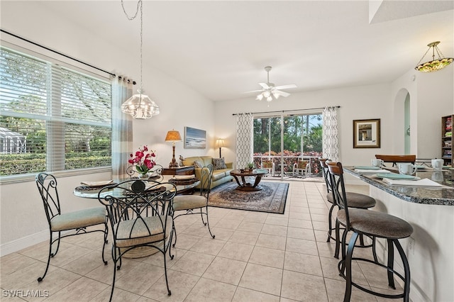 tiled dining space with ceiling fan