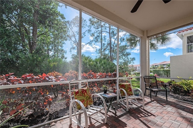 sunroom featuring a ceiling fan