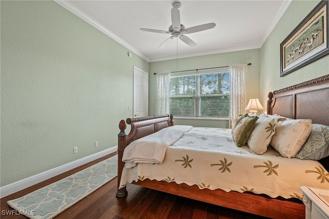 bedroom featuring a textured wall, baseboards, crown molding, and wood finished floors