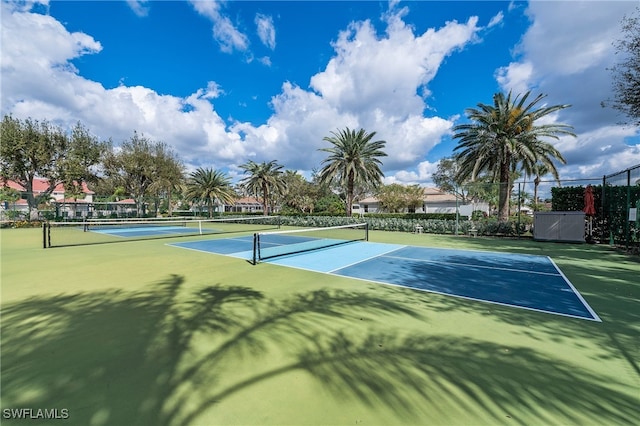 view of sport court featuring fence