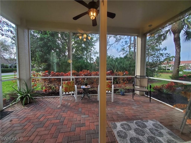 sunroom featuring a ceiling fan