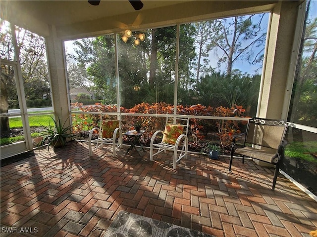 sunroom / solarium featuring ceiling fan