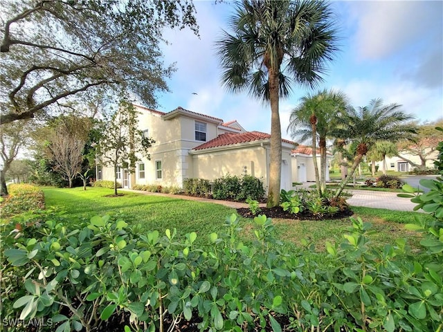 view of side of home featuring a yard