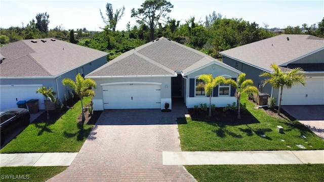 ranch-style home featuring a garage and a front lawn