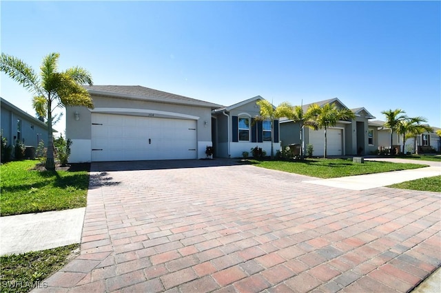 single story home with a front yard and a garage