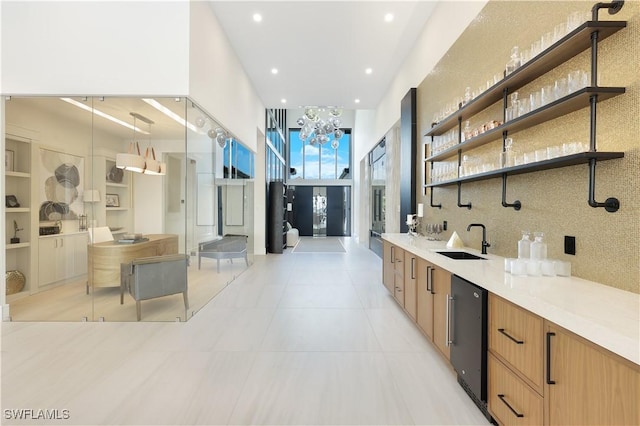 bathroom with a notable chandelier, recessed lighting, decorative backsplash, vanity, and tile patterned floors