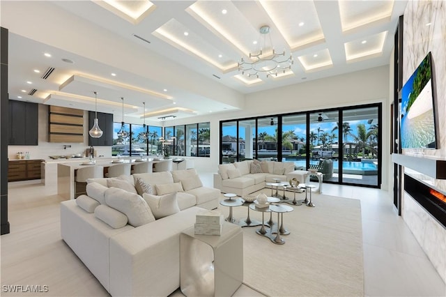 living area featuring plenty of natural light, a high ceiling, coffered ceiling, and recessed lighting