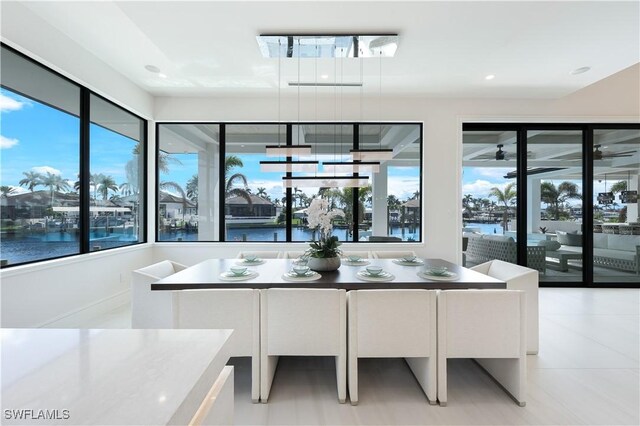 dining area with a water view and recessed lighting