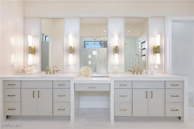 bathroom with tiled shower and vanity