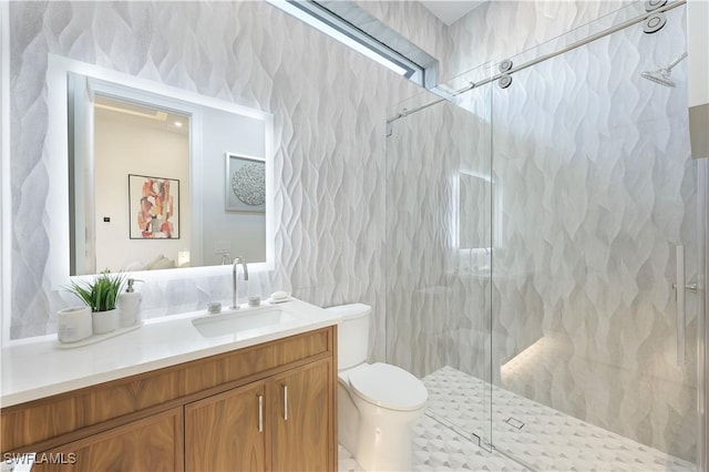 bathroom with tile walls, toilet, vanity, and a marble finish shower