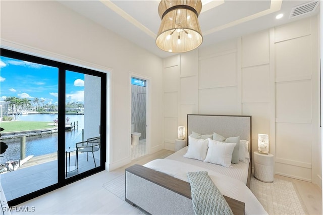 5346 Baypoint Ct, Cape Coral, FL 33904 - bedroom featuring access to outside, a water view, ensuite bathroom, recessed lighting, and light wood finished floors