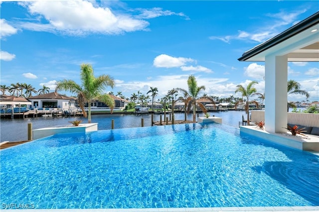 view of swimming pool featuring a water view