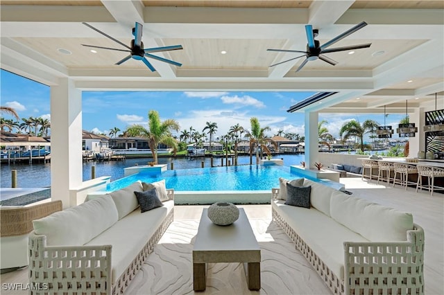 view of swimming pool with a water view, an outdoor living space, and a ceiling fan