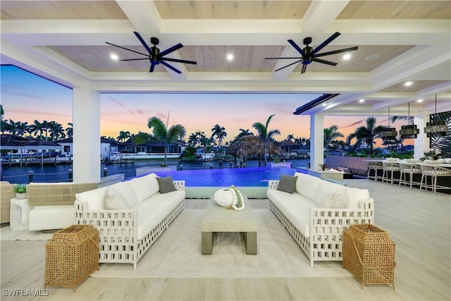 5346 Baypoint Ct, Cape Coral, FL 33904 - pool at dusk with ceiling fan, an outdoor living space, an outdoor pool, and a water view