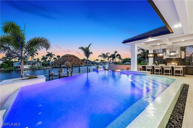 5346 Baypoint Ct, Cape Coral, FL 33904 - pool at dusk with a gazebo and a water view