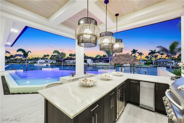5346 Baypoint Ct, Cape Coral, FL 33904 - patio terrace at dusk featuring wine cooler and a water view