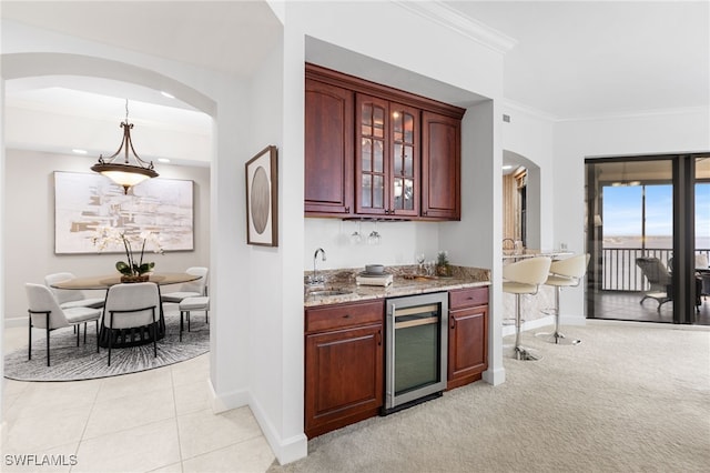 11600 Court Of Palms Unit 606, Fort Myers, FL 33908 - indoor wet bar with wine cooler, arched walkways, ornamental molding, light colored carpet, and light tile patterned flooring