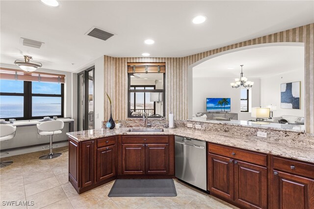 11600 Court Of Palms Unit 606, Fort Myers, FL 33908 - kitchen with dishwasher, arched walkways, light stone counters, a chandelier, and light tile patterned floors