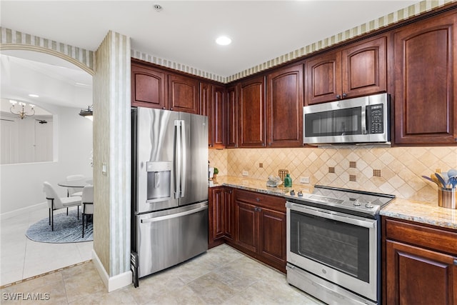 11600 Court Of Palms Unit 606, Fort Myers, FL 33908 - kitchen featuring stainless steel appliances, light stone countertops, tasteful backsplash, a chandelier, and recessed lighting