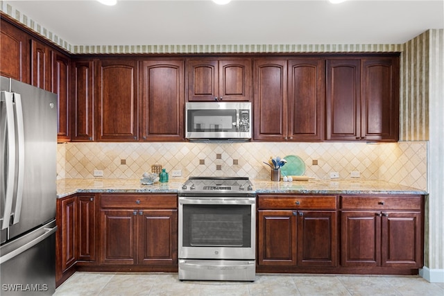 11600 Court Of Palms Unit 606, Fort Myers, FL 33908 - kitchen with appliances with stainless steel finishes, light stone counters, decorative backsplash, and dark brown cabinets