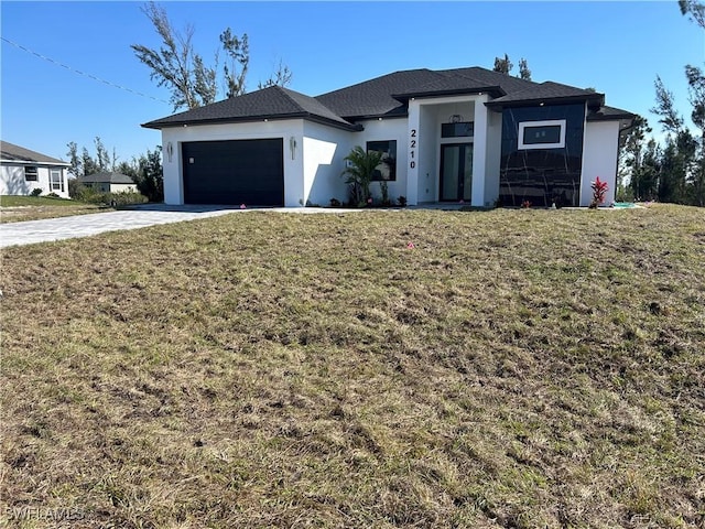 view of front of house featuring an attached garage, a front lawn, and concrete driveway