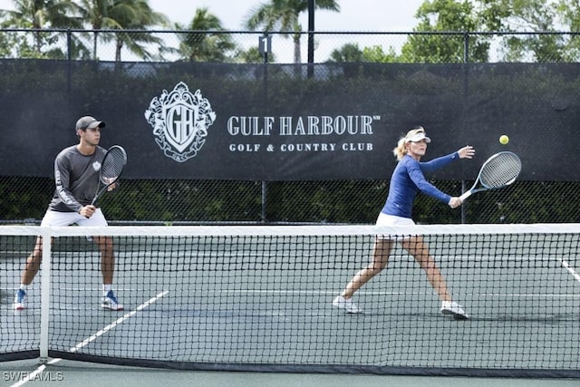 view of tennis court with fence