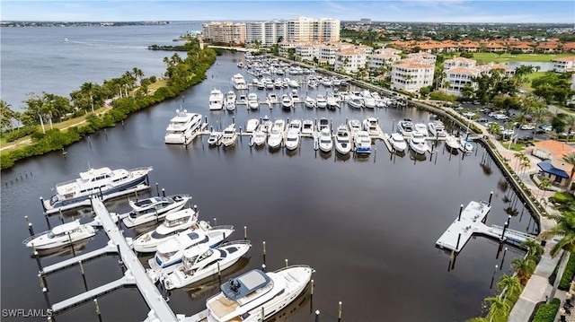 birds eye view of property with a view of city and a water view