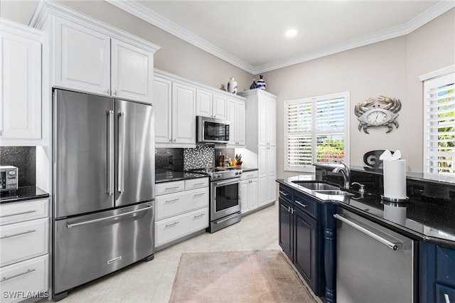 kitchen featuring light tile patterned floors, white cabinets, ornamental molding, stainless steel appliances, and a sink