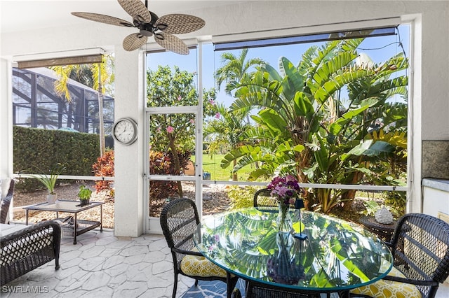 sunroom featuring ceiling fan