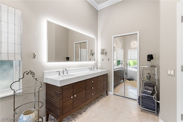 full bath with tile patterned flooring, a freestanding bath, a sink, and double vanity