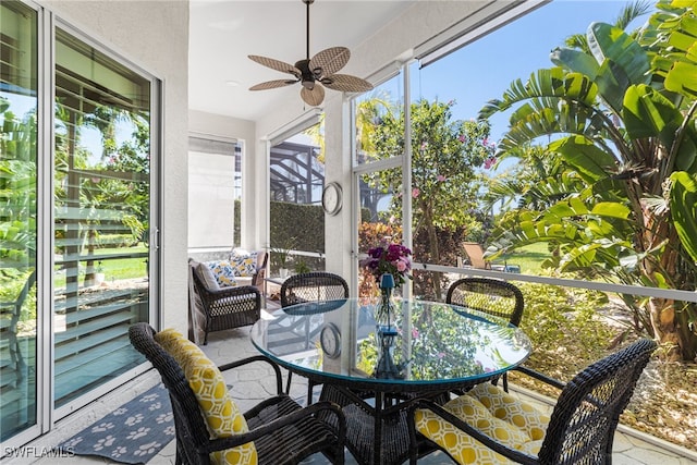 sunroom with a ceiling fan and a wealth of natural light