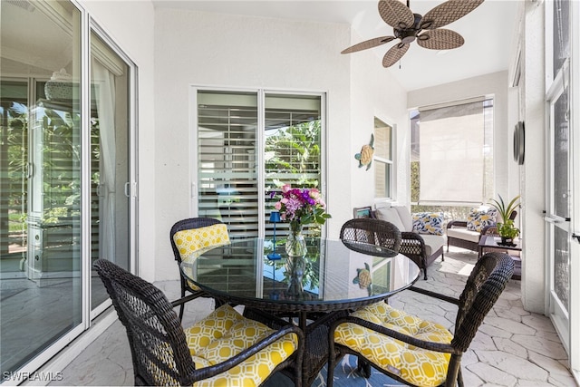 sunroom / solarium featuring ceiling fan