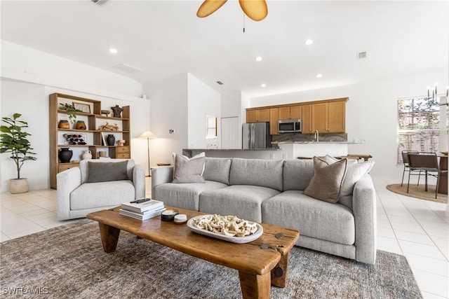 living room with light tile patterned floors, recessed lighting, lofted ceiling, visible vents, and ceiling fan with notable chandelier