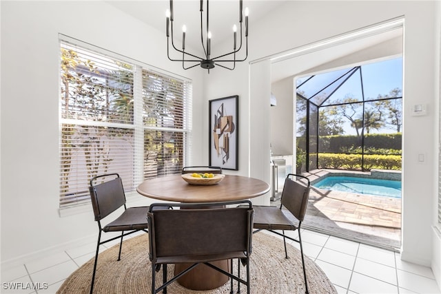 dining room featuring a sunroom, a healthy amount of sunlight, baseboards, and light tile patterned floors