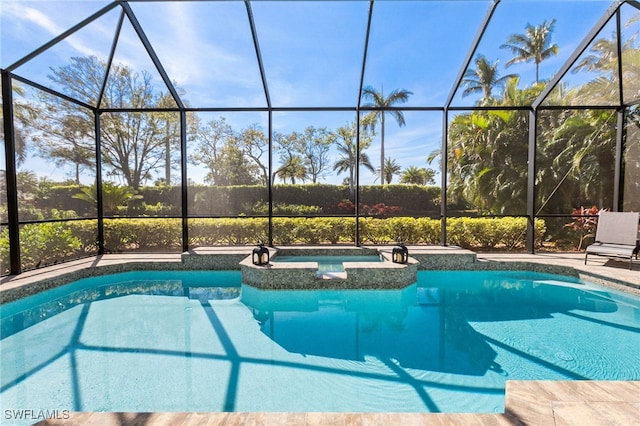 view of pool featuring a lanai and a pool with connected hot tub