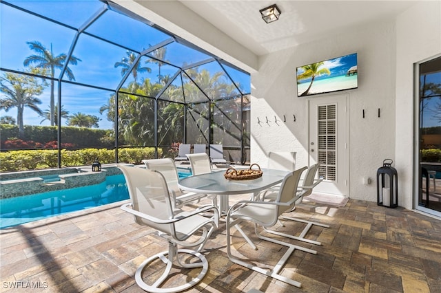 view of patio / terrace featuring a lanai and a pool with connected hot tub