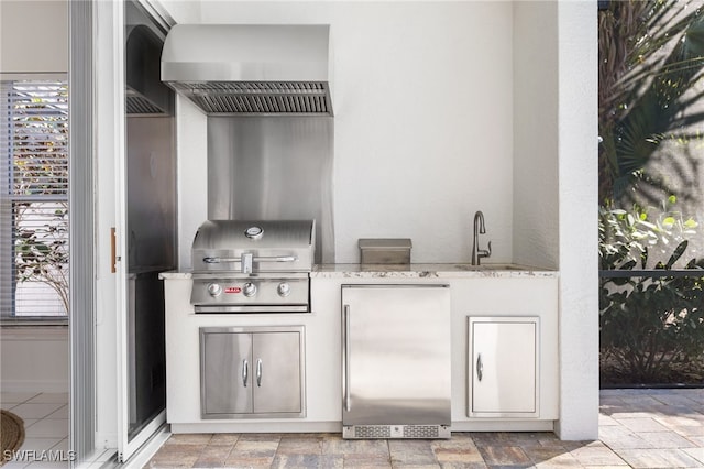 view of patio / terrace featuring exterior kitchen, a grill, and a sink