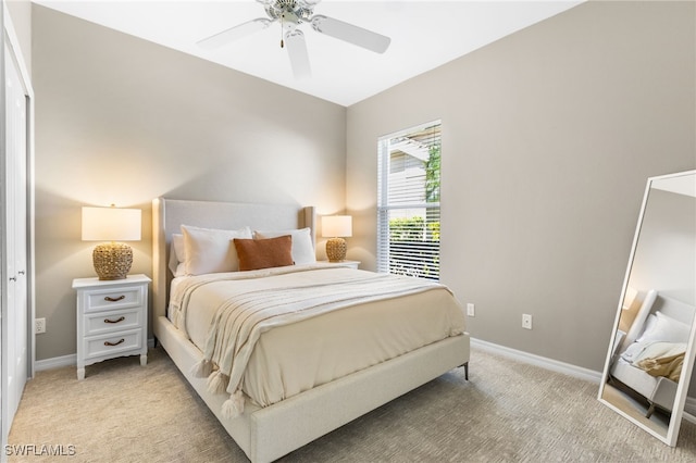 bedroom featuring light carpet, ceiling fan, and baseboards