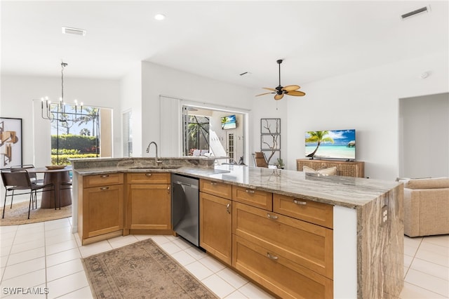 kitchen with light stone countertops, a sink, open floor plan, stainless steel dishwasher, and brown cabinets