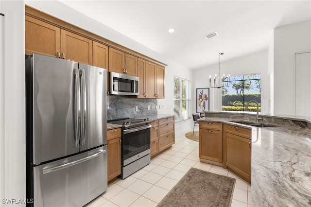 kitchen with light tile patterned floors, visible vents, hanging light fixtures, stainless steel appliances, and a sink