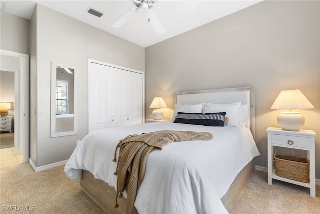 bedroom featuring a closet, light colored carpet, visible vents, ceiling fan, and baseboards