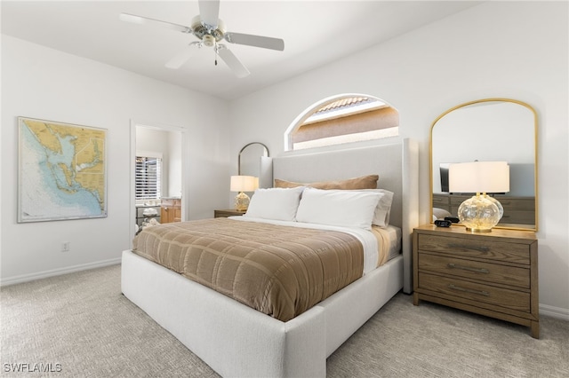 bedroom featuring light colored carpet, ceiling fan, and baseboards