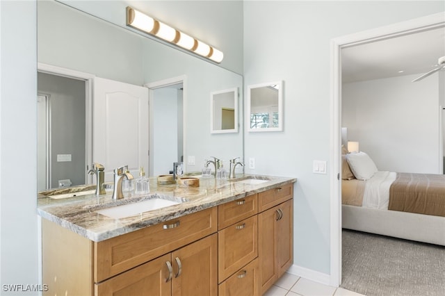 ensuite bathroom featuring tile patterned floors, a sink, and ensuite bathroom