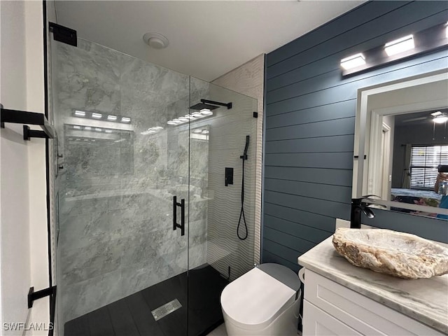 bathroom with vanity, an enclosed shower, wooden walls, and toilet