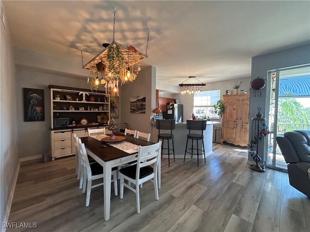 dining space featuring a chandelier and light hardwood / wood-style floors