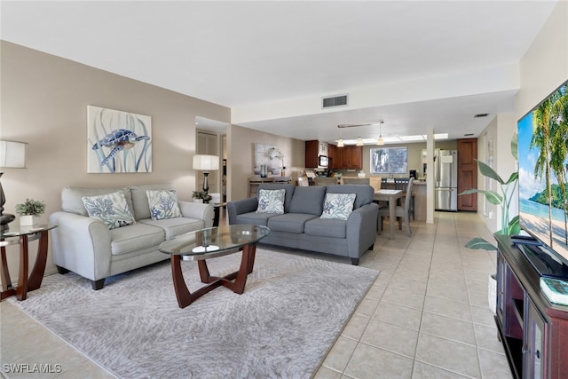 living room featuring light tile patterned floors and visible vents