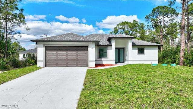 prairie-style home featuring a garage, concrete driveway, a front lawn, and stucco siding