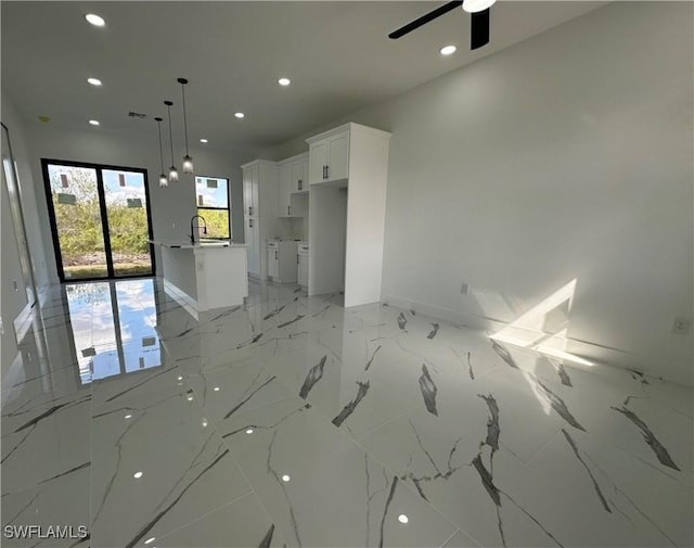 empty room featuring ceiling fan and sink