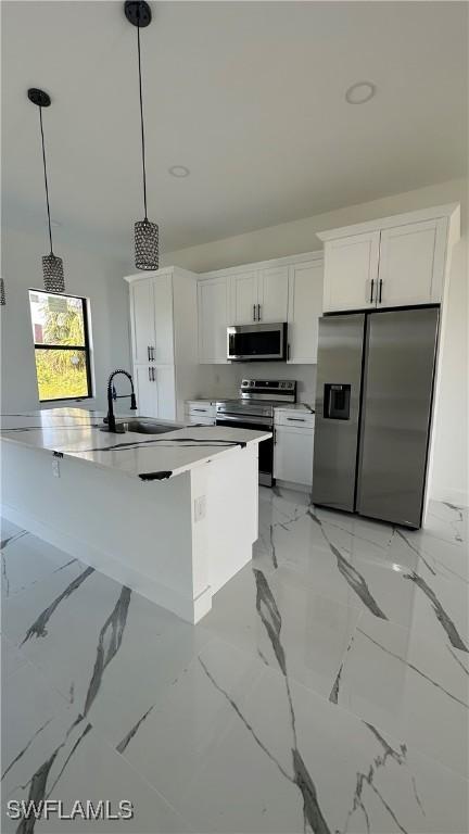 kitchen featuring a sink, stainless steel appliances, marble finish floor, and white cabinets